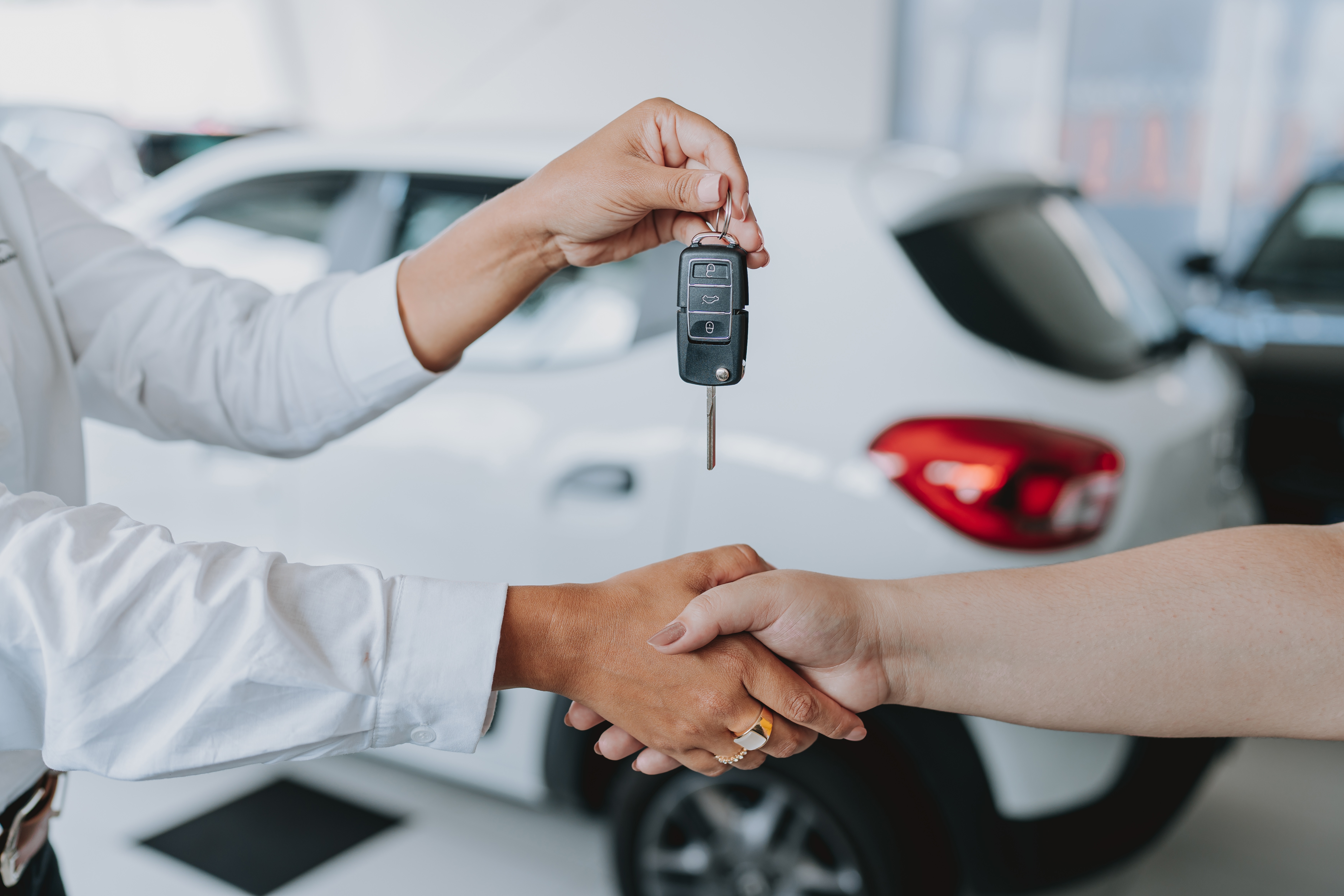 Car buyer receiving car keys 